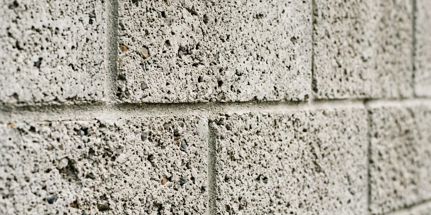spotless outdoor concrete block retaining wall, looking like new without water stains or mildew, resulting from Liberty SoftWash's pressure washing service.