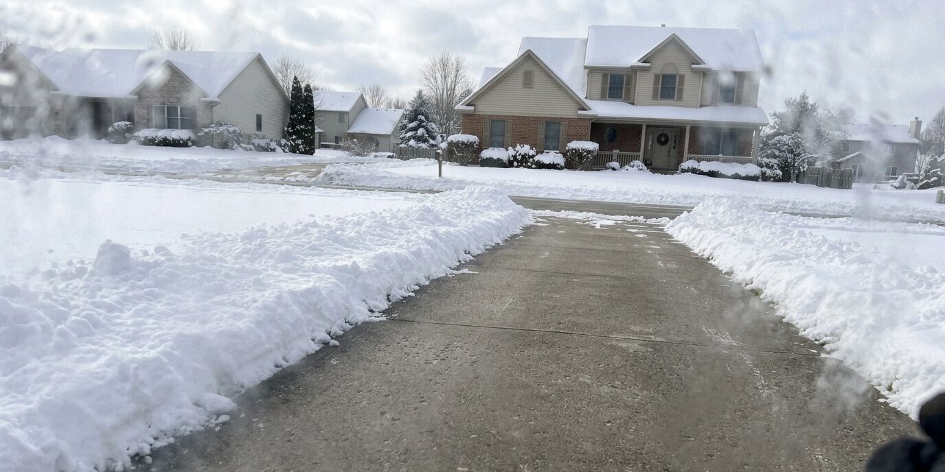 A fully cleared and salted public sidewalk, highlighting detailed snow shoveling and ice prevention services by Liberty SoftWash.
